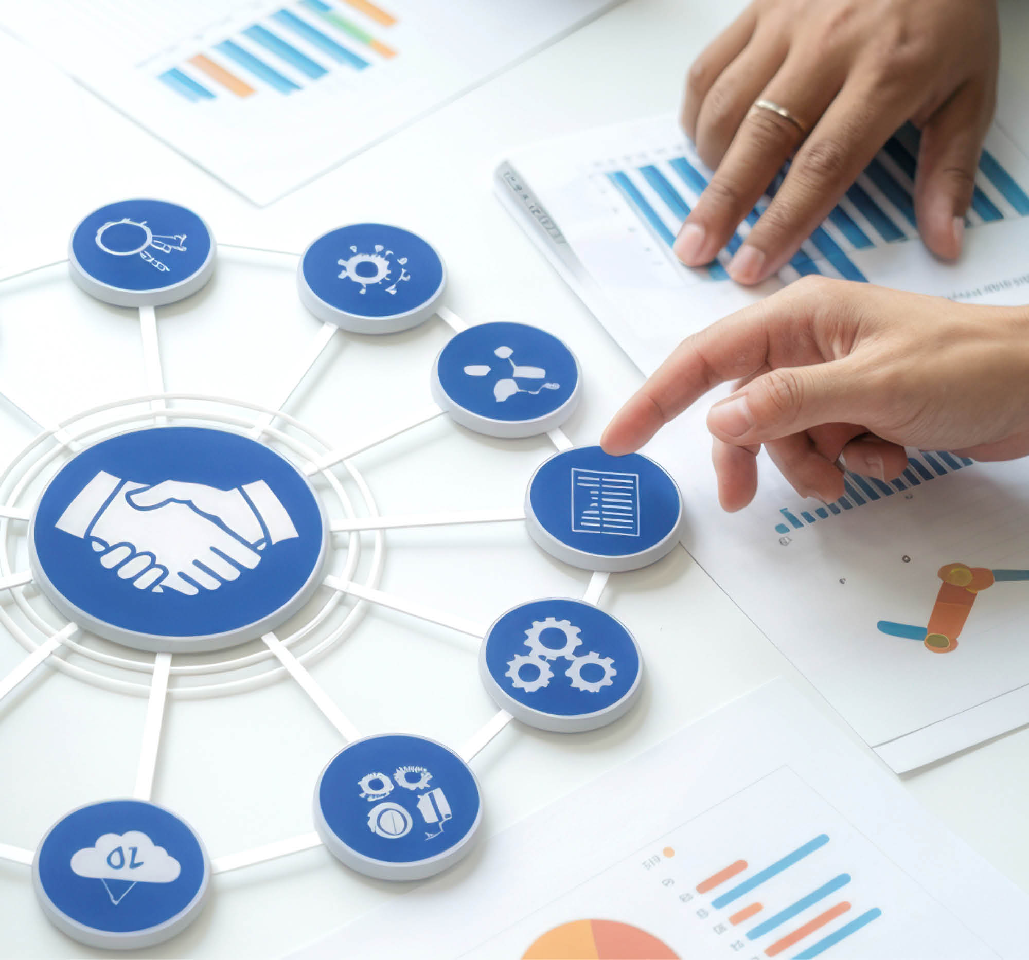 hands analyzing charts and pointing to connected icons symbolizing business collaboration and data analysis